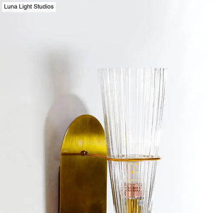 Brass ribbed glass wall lamp with tall clear shade, wall-mounted fixture on Tampa Home & Garden Store