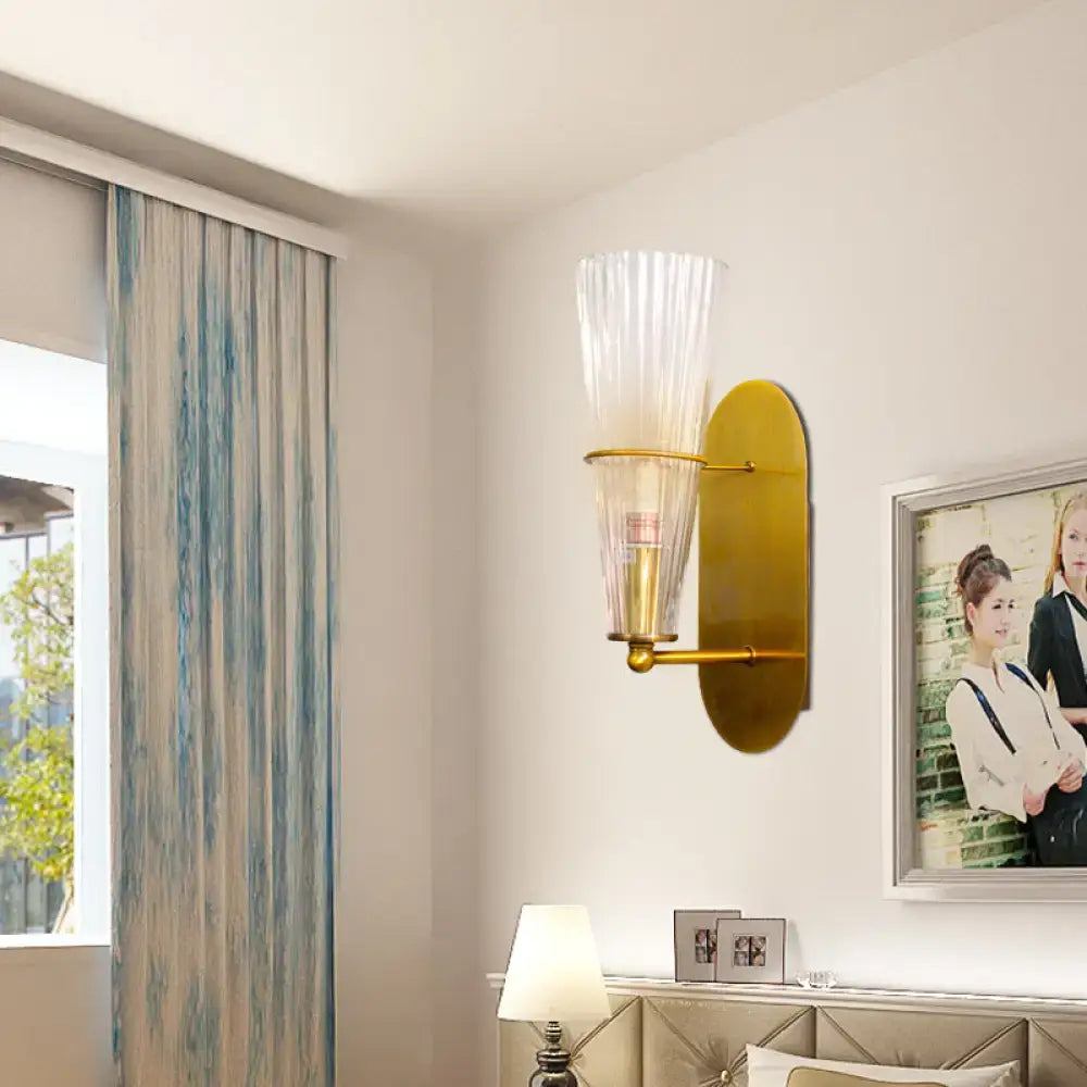 Brass ribbed glass wall lamp by Decorbites with tall ribbed shade and oval backplate on wall on Tampa Home & Garden Store