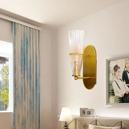 Brass ribbed glass wall lamp by Decorbites with tall ribbed shade and oval backplate on wall on Tampa Home & Garden Store