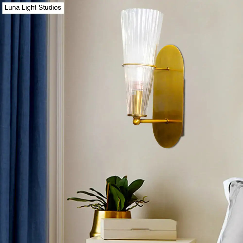 Brass ribbed glass wall lamp sconce with gold finish and clear ribbed shade on Tampa Home & Garden Store