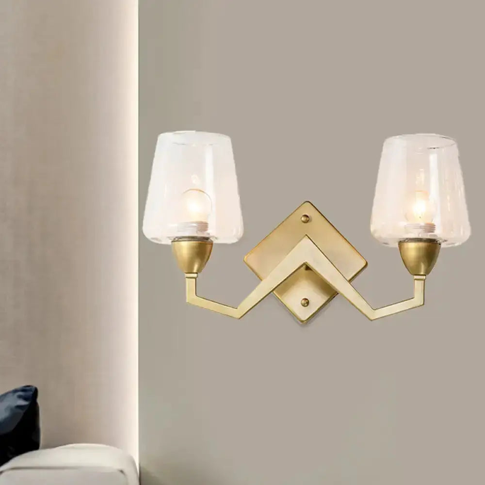 Mid-century brass wall lamp with two arms and truncated cone clear glass shades on Tampa Home & Garden Store