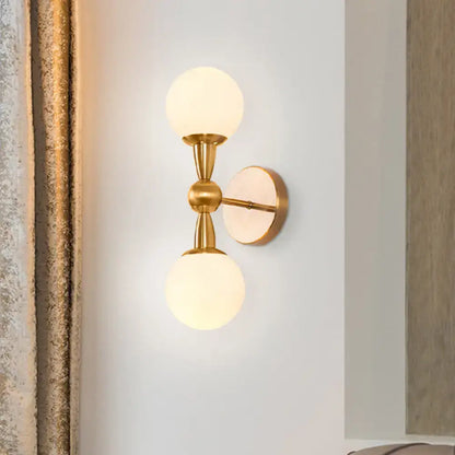 Brass opal glass orb wall sconce by Decorbites, dual globe gold-tone fixture on Tampa Home & Garden Store