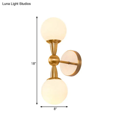 Brass opal glass orb wall sconce with two frosted globes in brass finish by Decorbites on Tampa Home & Garden Store