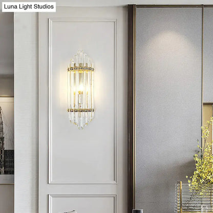 Gold crystal pipe sconce with vertical crystal rods and candle bulb by Decorbites on Tampa Home & Garden Store