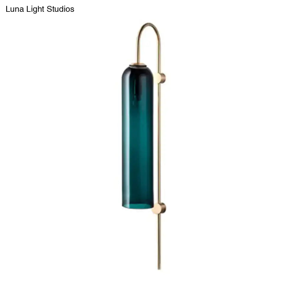 Brass gooseneck wall sconce with teal glass cylinder on Tampa Home & Garden Store