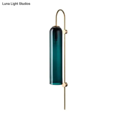 Brass gooseneck wall sconce with teal glass cylinder on Tampa Home & Garden Store