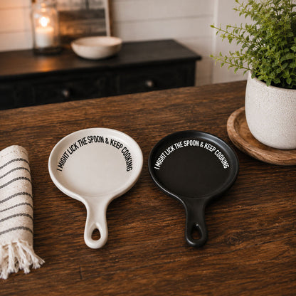 Gia Roma Lick the Spoon & Cook spoon rests in white and black with curved text around edge on Tampa Home & Garden Store