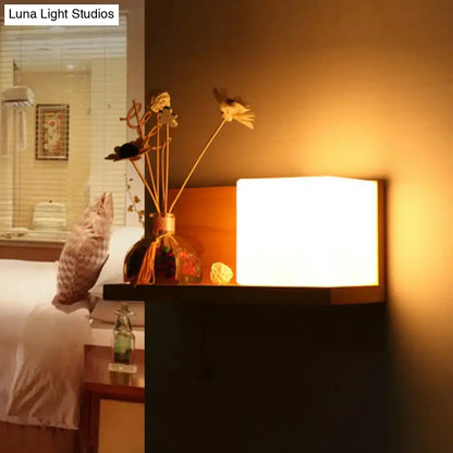 Milk Glass Cube Sconce by Decorbites; warm bedside light on wood nightstand on Tampa Home & Garden Store