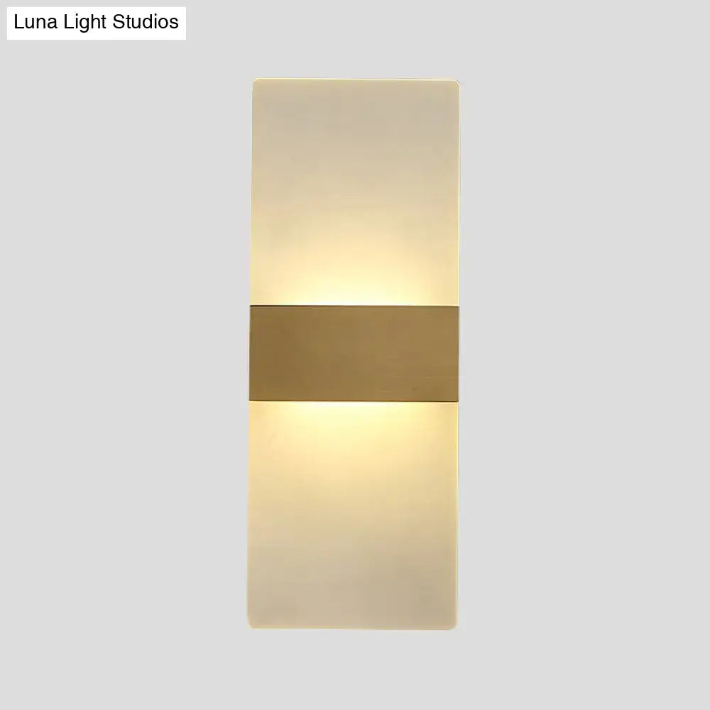Decorbites gold acrylic direct-wired wall sconce with a horizontal gold band and warm glow on Tampa Home & Garden Store