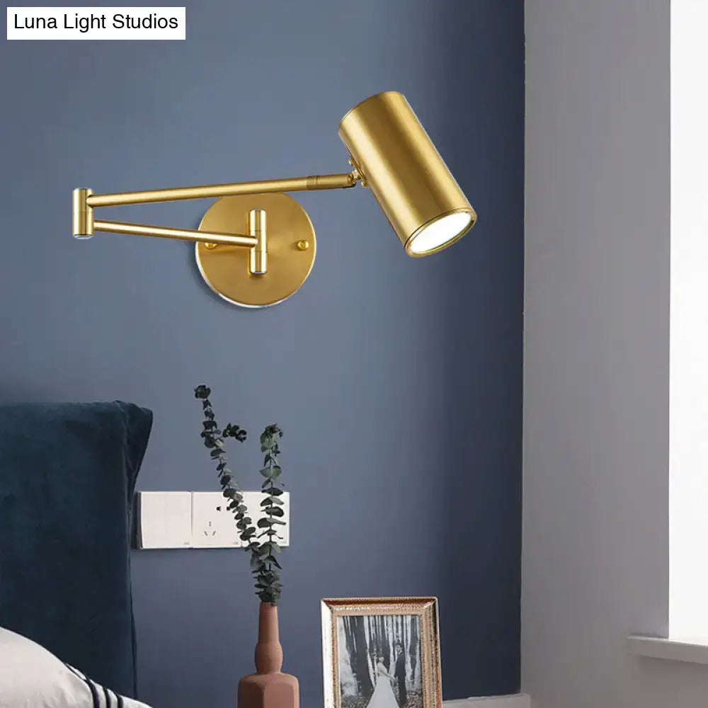 Black Gold Cylinder Wall Light Decorbites brass finish with adjustable arm mounted on blue wall on Tampa Home & Garden Store