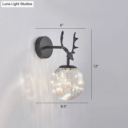 Black Antler Glass Sconce with clear glass orb and warm LED lights by Decorbites on Tampa Home & Garden Store