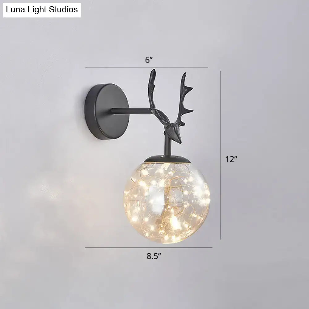 Black antler glass sconce with glowing glass globe, black metal backplate Decorbites on Tampa Home & Garden Store