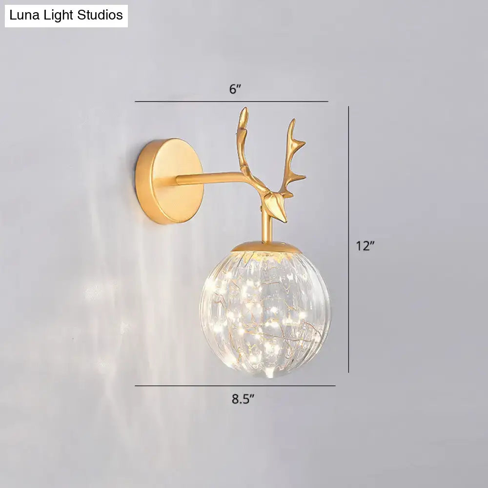 Black Antler Glass Sconce with brass-finish deer antler mount and clear glass globe on Tampa Home & Garden Store
