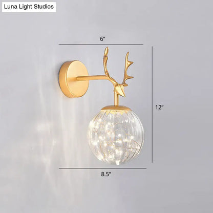 Black Antler Glass Sconce with brass-finish deer antler mount and clear glass globe on Tampa Home & Garden Store