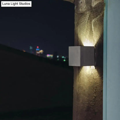 Grey Cement Square Wall Lamp by Decorbites on textured stone wall at night on Tampa Home & Garden Store