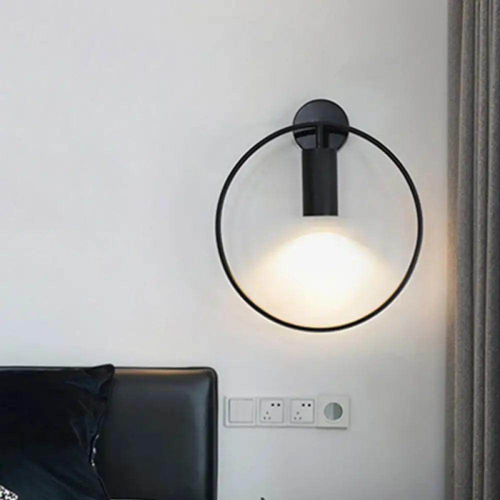 Black circular metal sconce with ring frame and wall-mount cylinder light by Decorbites on Tampa Home & Garden Store