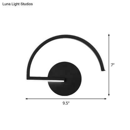 Black curved open-frame wall sconce by Decorbites; matte black metal with circular backplate on Tampa Home & Garden Store