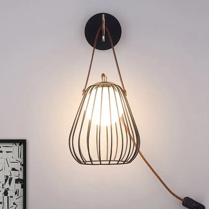 Black Pear Cage Matte Wall Sconce by Decorbites; metal pear-shaped cage with warm bulb, suspended by brown strap on Tampa Home & Garden Store
