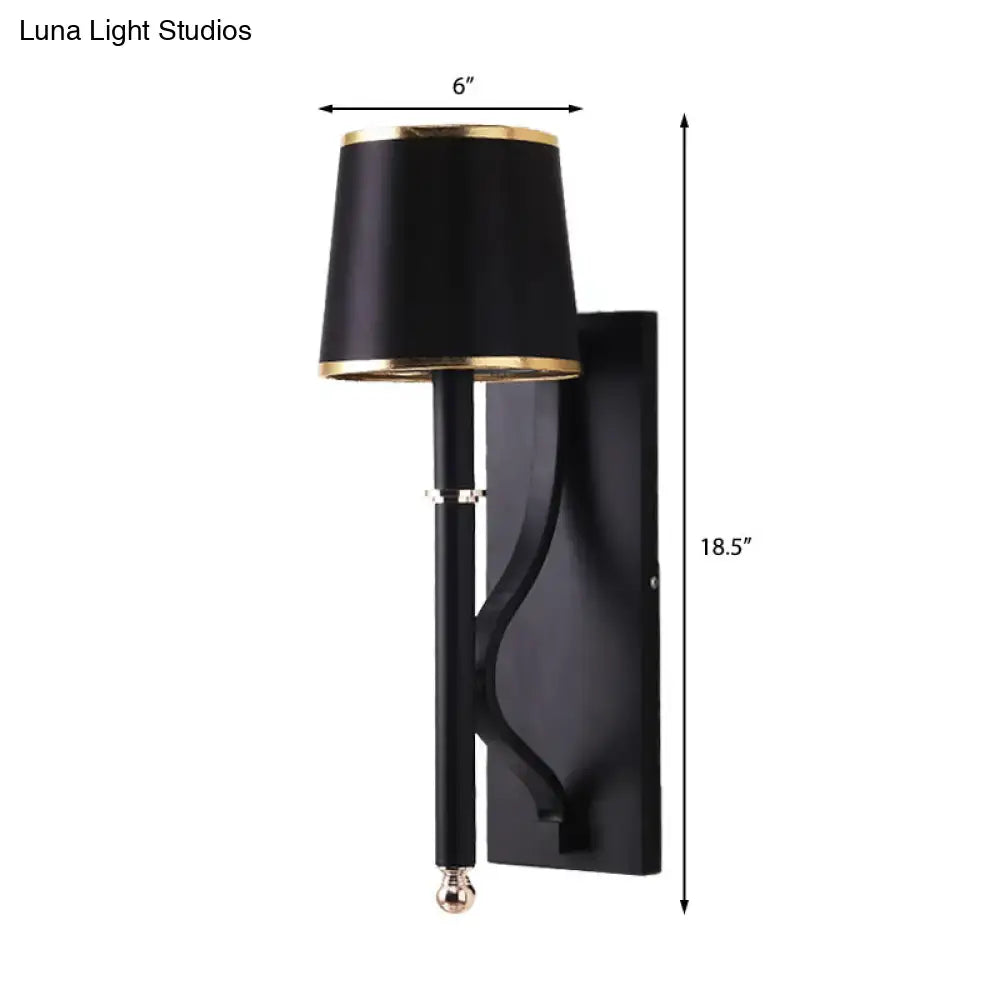 Decorbites Black Flaxen Cone Wall Sconce with black shade and gold trim on a black mount on Tampa Home & Garden Store
