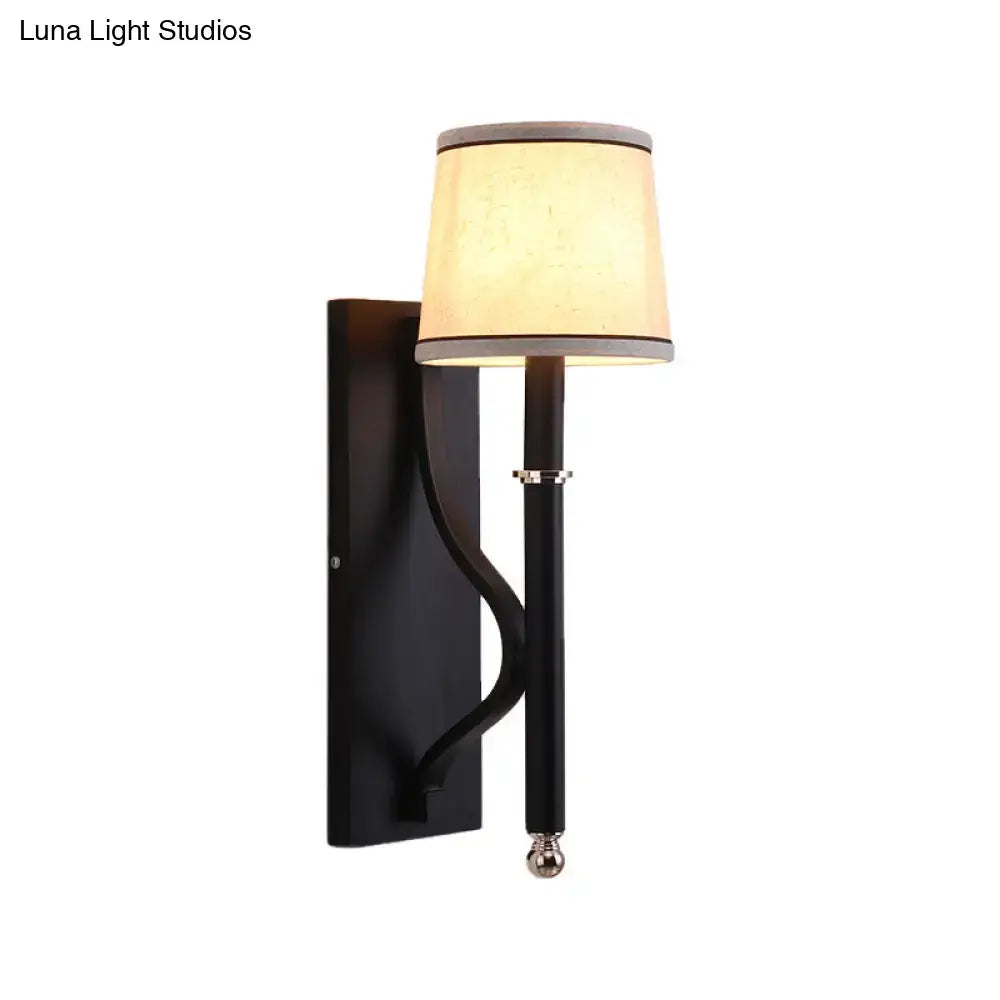 Black flaxen cone wall sconce with flaxen fabric shade and curved metal arm on Tampa Home & Garden Store