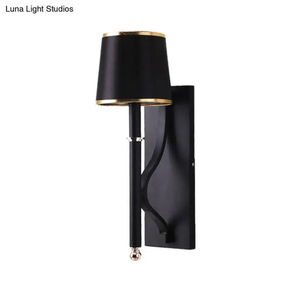 Black flaxen cone wall sconce with gold trim and slim vertical stem wall mounted on Tampa Home & Garden Store