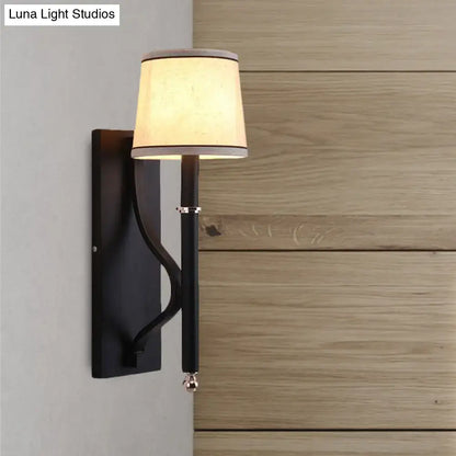 Black flaxen cone wall sconce with cream shade and black metal backplate by Decorbites on Tampa Home & Garden Store