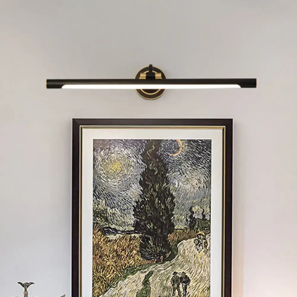 Black gold adjustable wall sconce with long light bar and round mount above framed art on Tampa Home & Garden Store