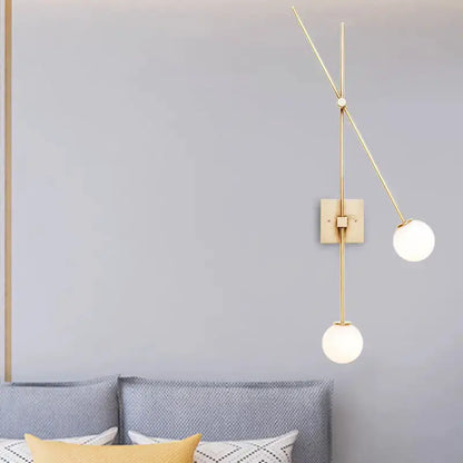 Minimalist black & gold opal glass bubble sconce with two globes on vertical gold rod on Tampa Home & Garden Store