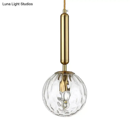Black Gold Glass Globe Wall Sconce with brass finish and clear textured glass globe on Tampa Home & Garden Store