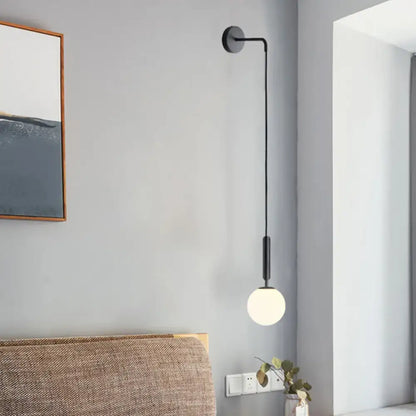 Black Gold Glass Globe Wall Sconce by Decorbites; matte black arm with frosted globe on Tampa Home & Garden Store