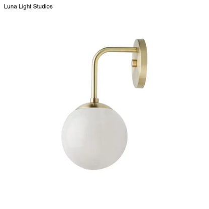 Milky Glass Ball Wall Lamp with brass curved arm and wall-mount plate on Tampa Home & Garden Store