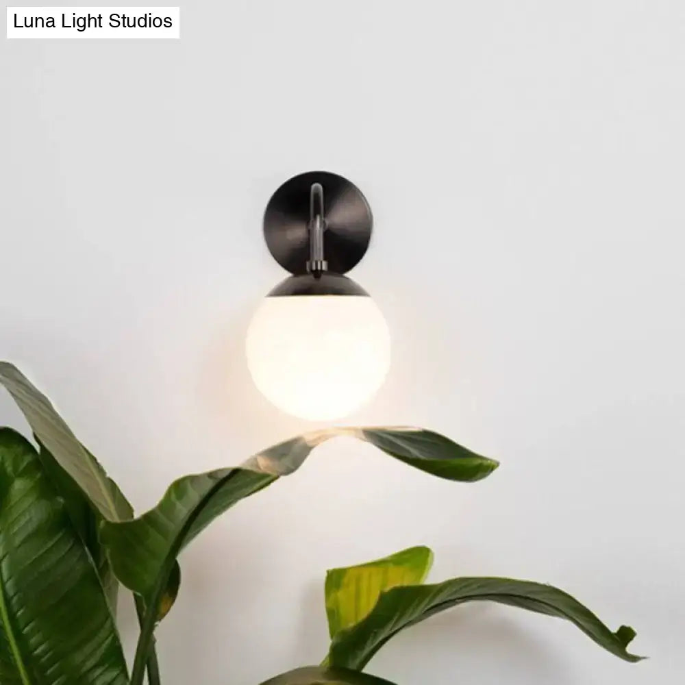Milky Glass Ball Wall Lamp by Decorbites with a black metal backplate on Tampa Home & Garden Store
