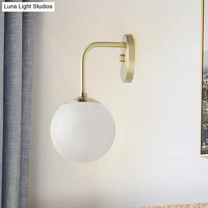 Milky glass ball wall lamp with brass arc and round wall mount by Decorbites on Tampa Home & Garden Store