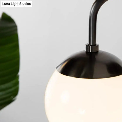 Decorbites Milky Glass Ball Wall Lamp with black metal top and curved arm on Tampa Home & Garden Store