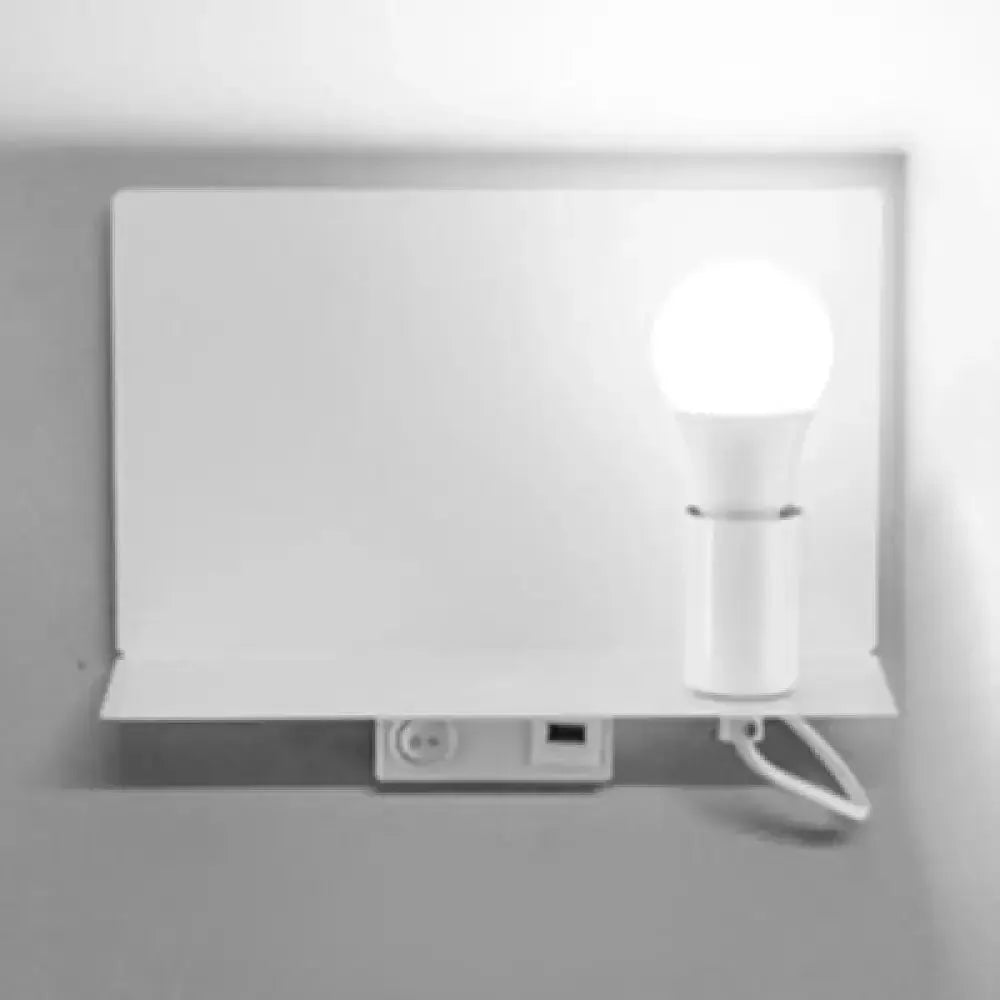 Minimalist black metal wall light with cylindrical bulb holder on a white backplate on Tampa Home & Garden Store