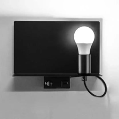 Minimalist black metal wall light with exposed bulb and cord loop on Tampa Home & Garden Store