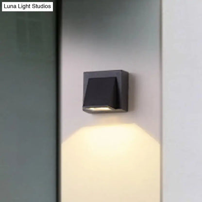 Black metal triangle wall lamp Decorbites with warm downward light on Tampa Home & Garden Store