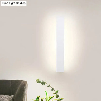 White aluminum wall sconce, vertical rectangular LED wall light with soft glow on Tampa Home & Garden Store