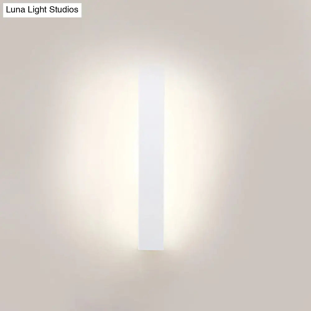 White aluminum wall sconce by Decorbites, vertical light bar with soft ambient glow on Tampa Home & Garden Store