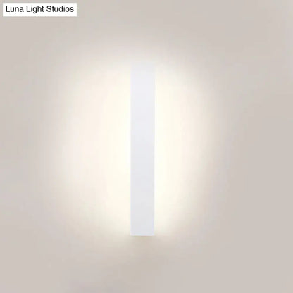 White aluminum wall sconce by Decorbites, vertical light bar with soft ambient glow on Tampa Home & Garden Store
