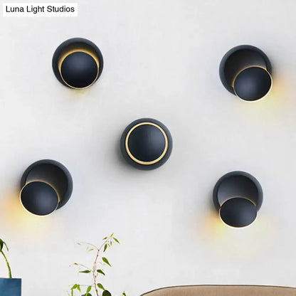 Five black circular LED stairway wall lamps with gold inner ring on a light wall on Tampa Home & Garden Store