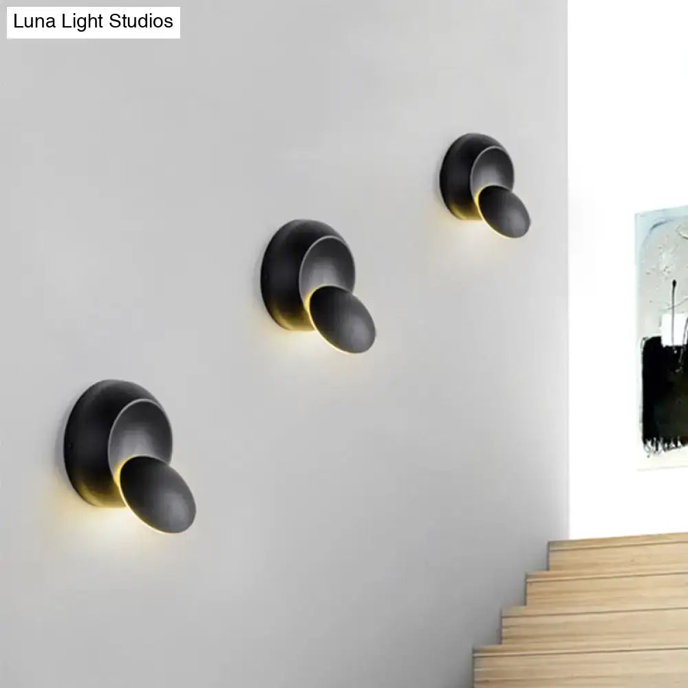 Three black circular LED stairway wall lamps by Decorbites, wall-mounted with warm downward glow on Tampa Home & Garden Store