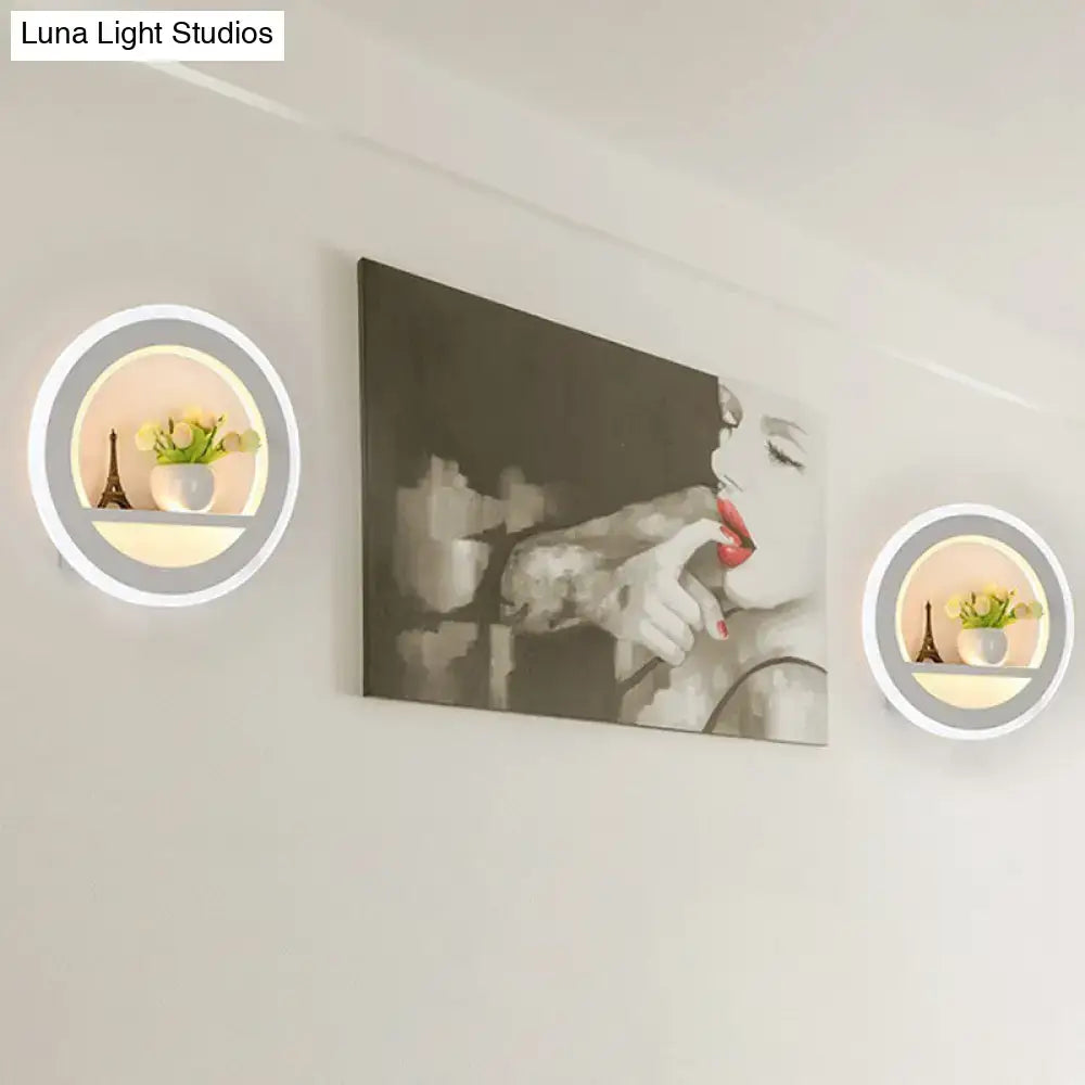 White circular LED sconce pair with shelf; Eiffel figurine and vase with flowers by Decorbites on Tampa Home & Garden Store
