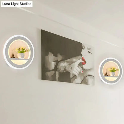 White circular LED sconce pair with shelf; Eiffel figurine and vase with flowers by Decorbites on Tampa Home & Garden Store