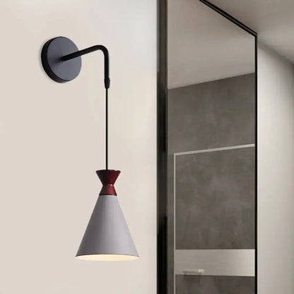 Black conical iron minimalist sconce by Decorbites with white shade and red collar on Tampa Home & Garden Store