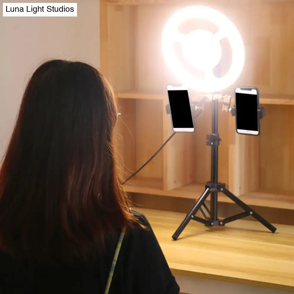 Black LED phone holder by Decorbites with dual mounts on a tripod stand beside a ring light on Tampa Home & Garden Store
