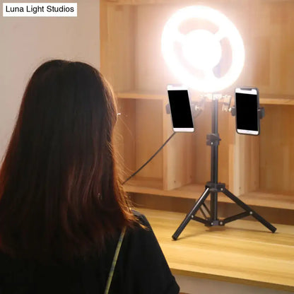 Black LED phone holder by Decorbites with dual mounts on a tripod stand beside a ring light on Tampa Home & Garden Store