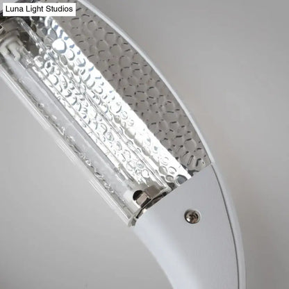 Black oval aluminum LED wall sconce with silver textured reflector panel by Decorbites on Tampa Home & Garden Store