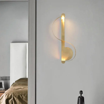 Brass Curve Wall Light modern brass wall sconce with looping rings and warm glow on Tampa Home & Garden Store