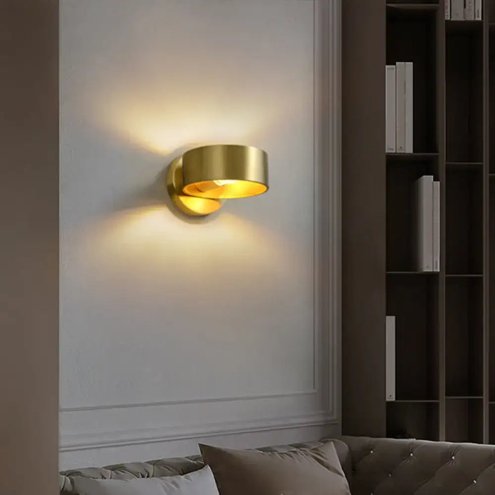 Brass curved wall lamp by Decorbites; gold-toned wall sconce with warm ambient glow on Tampa Home & Garden Store